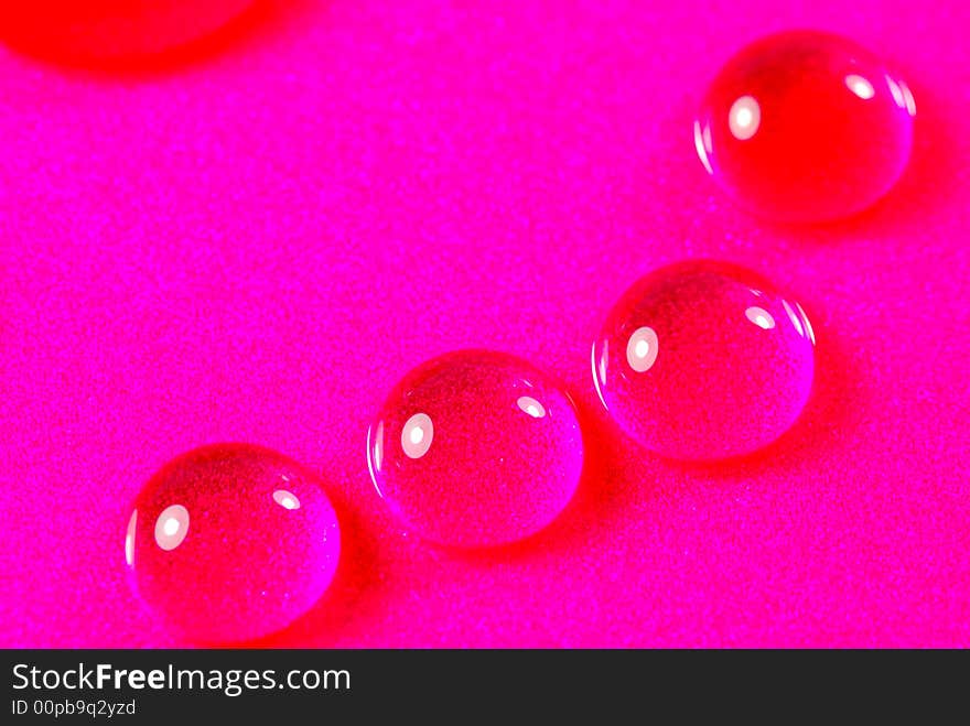 Close up shoot of pink colored water drops. Close up shoot of pink colored water drops