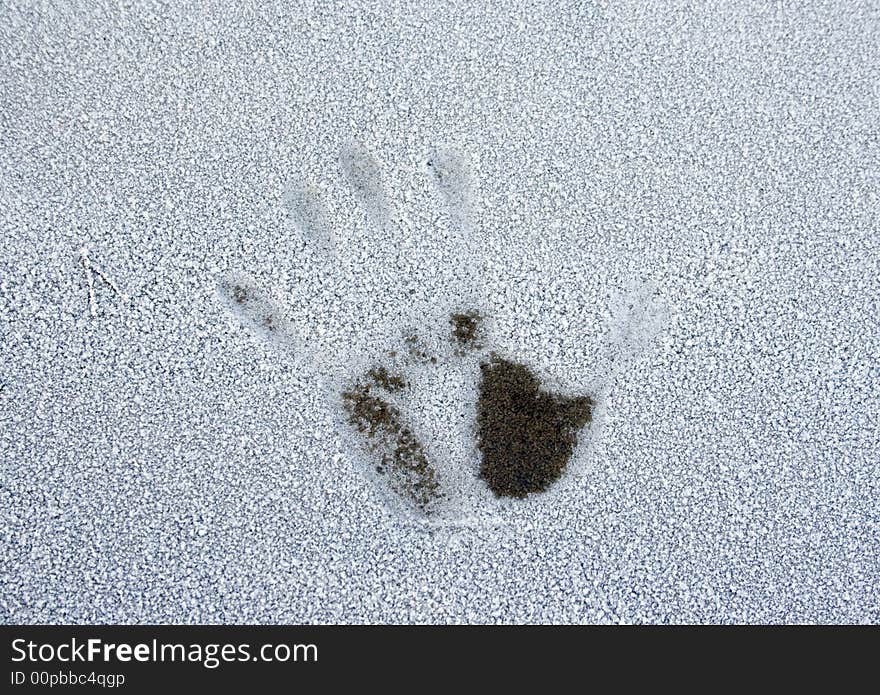 One hand print on the frozen surface