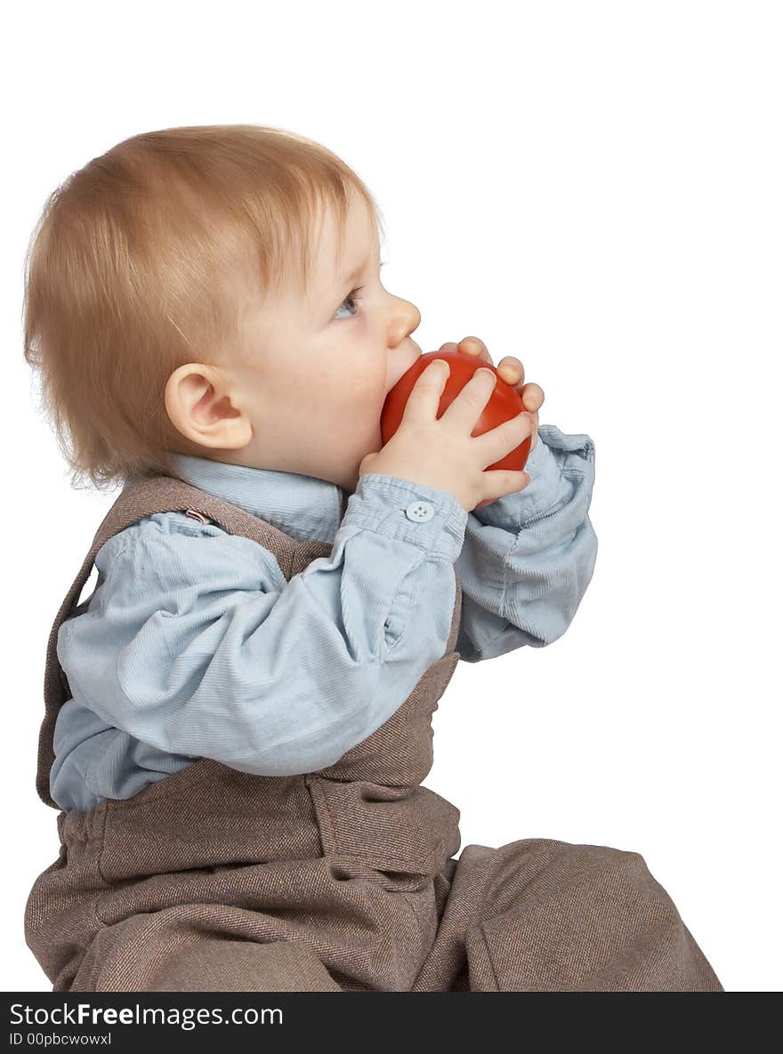 One-year boy eats a tomato. One-year boy eats a tomato.