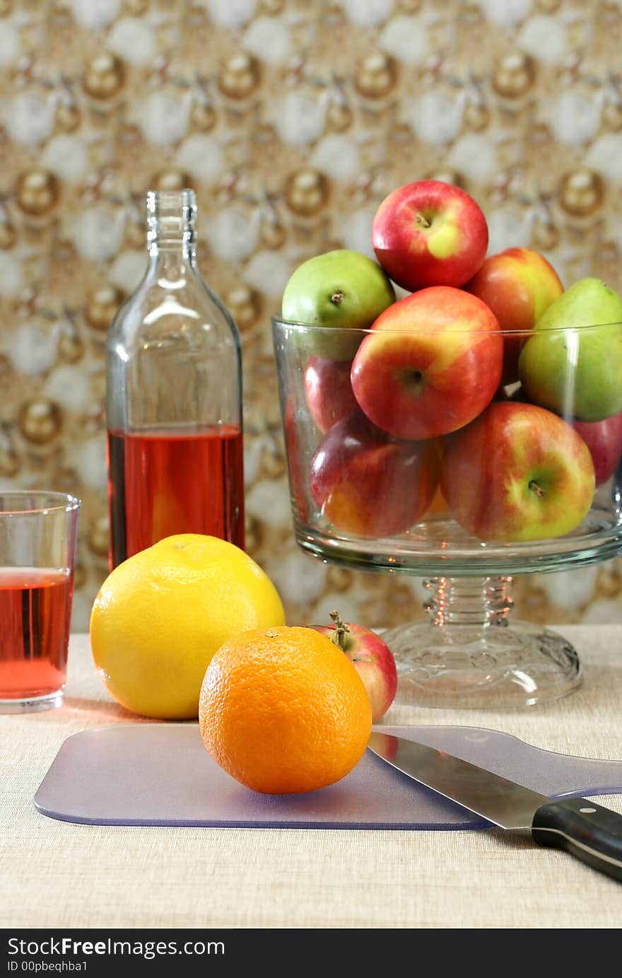 A table set with fresh apples and oranges