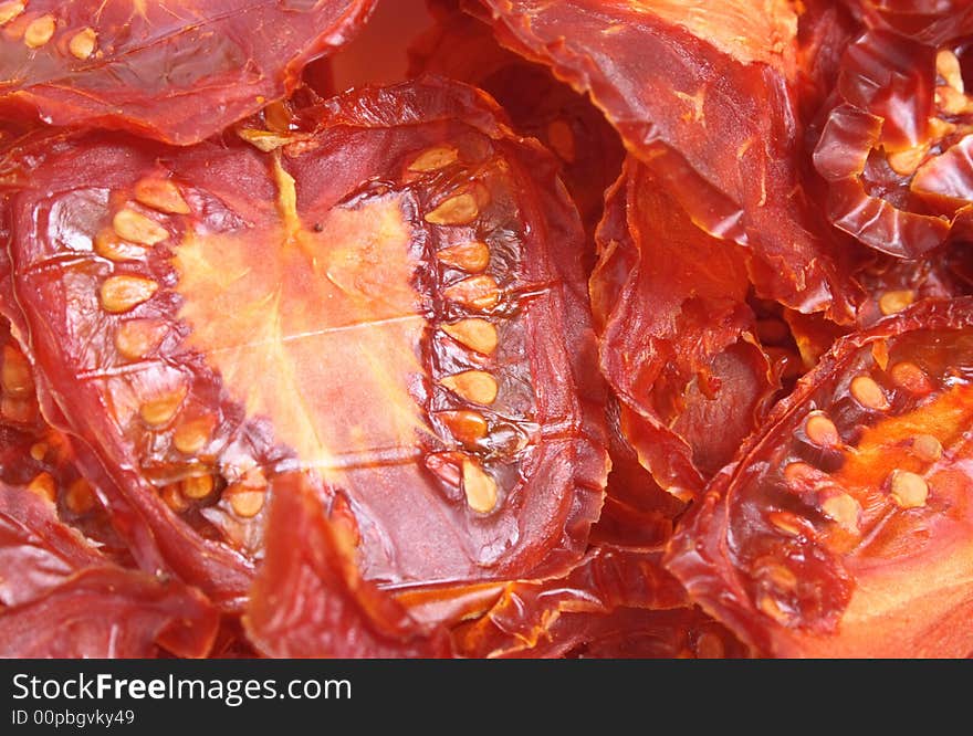 Tomato background from the dried slices of tomatoes