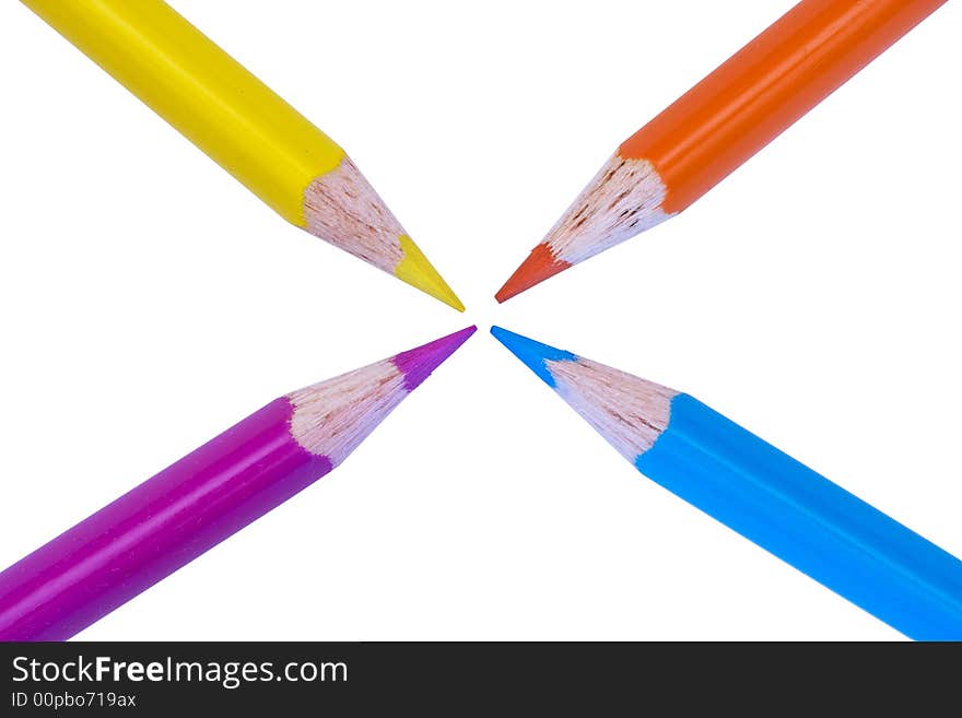 4 colored pencils all pointing to center of page on white background. 4 colored pencils all pointing to center of page on white background