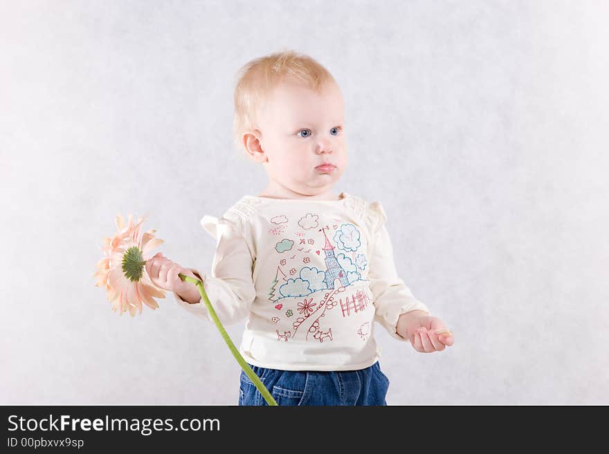 The girl with a pink flower in hands