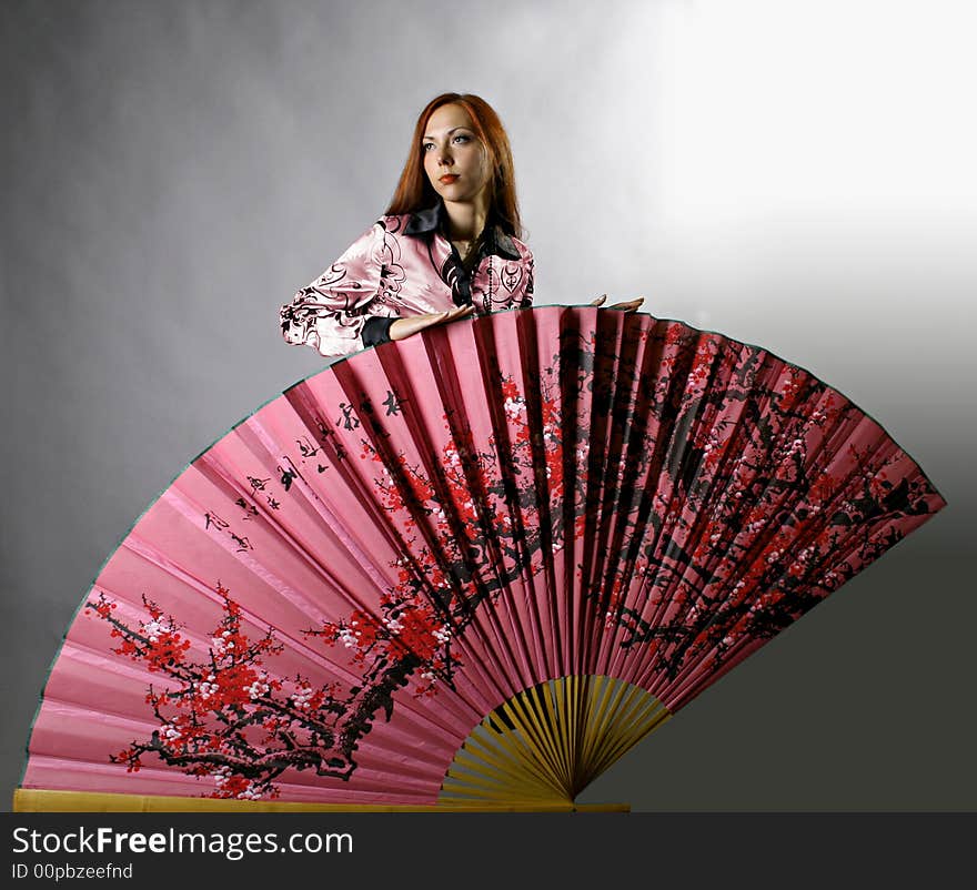 Beautiful girl with japanese pink fan. Beautiful girl with japanese pink fan