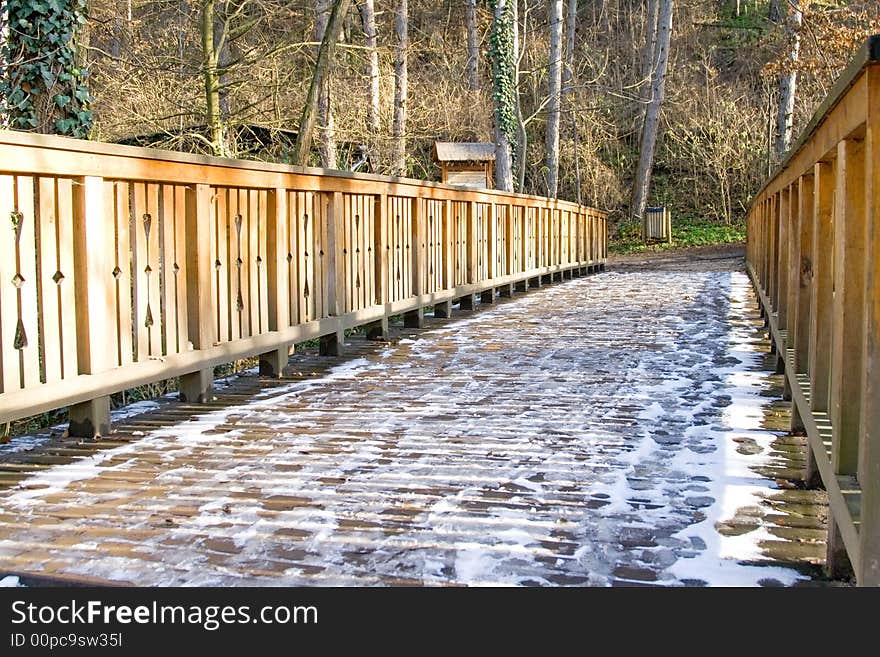 Wooden bridge in a park the frozen with snow. Wooden bridge in a park the frozen with snow.