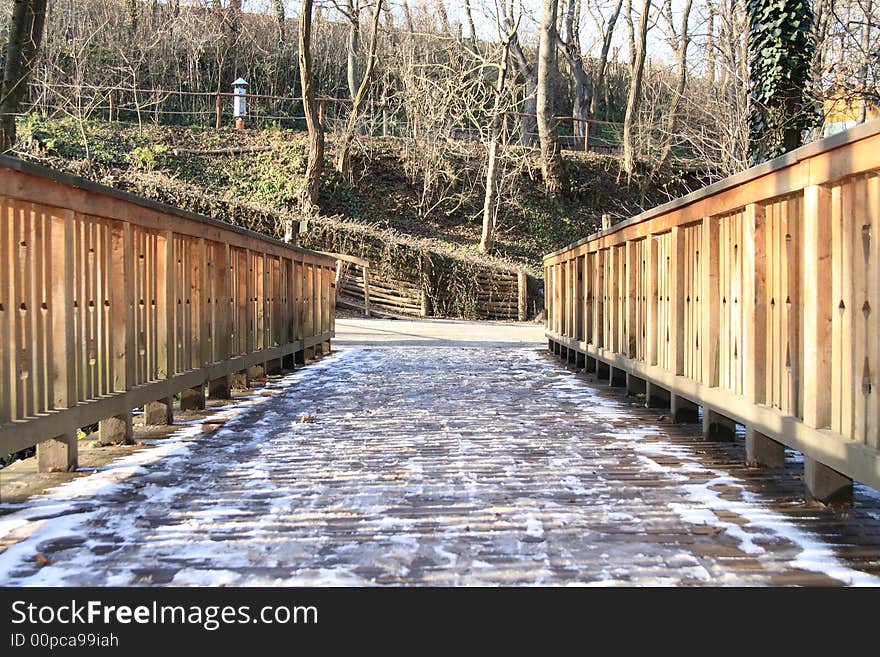 Wooden bridge in a park the frozen with snow. Wooden bridge in a park the frozen with snow.