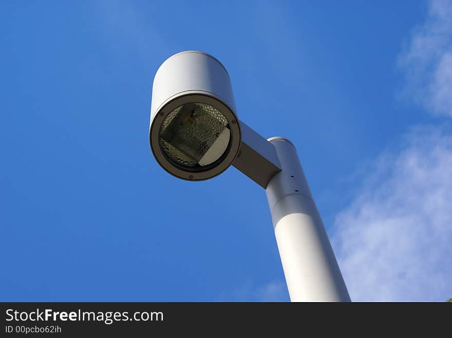 Street lamp against a blue sky