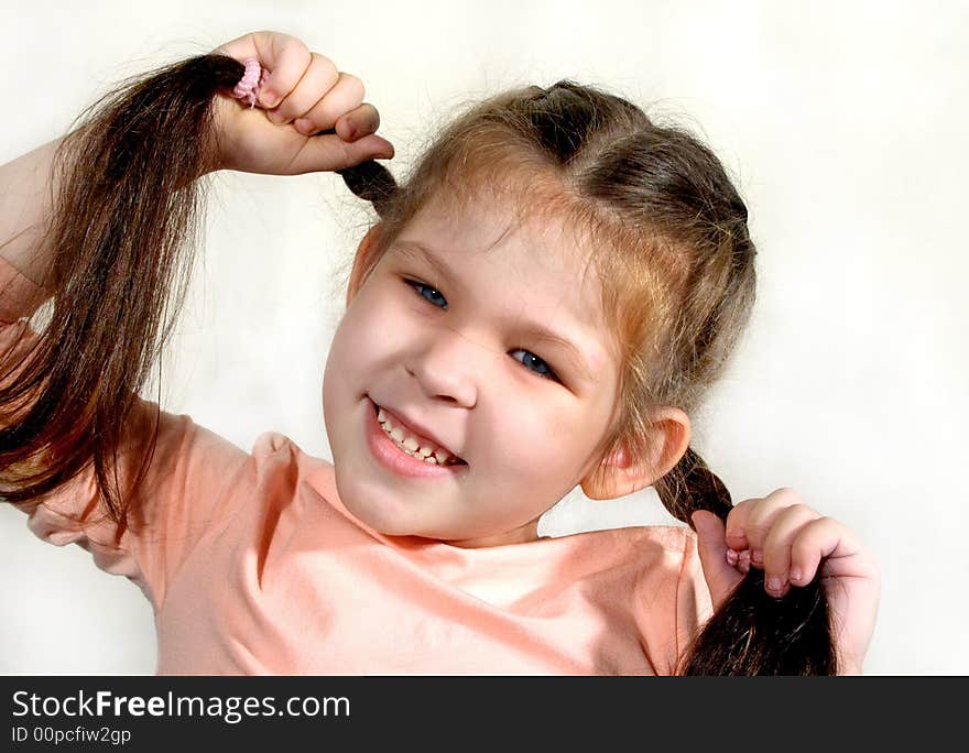 The girl holding her braids, portrait