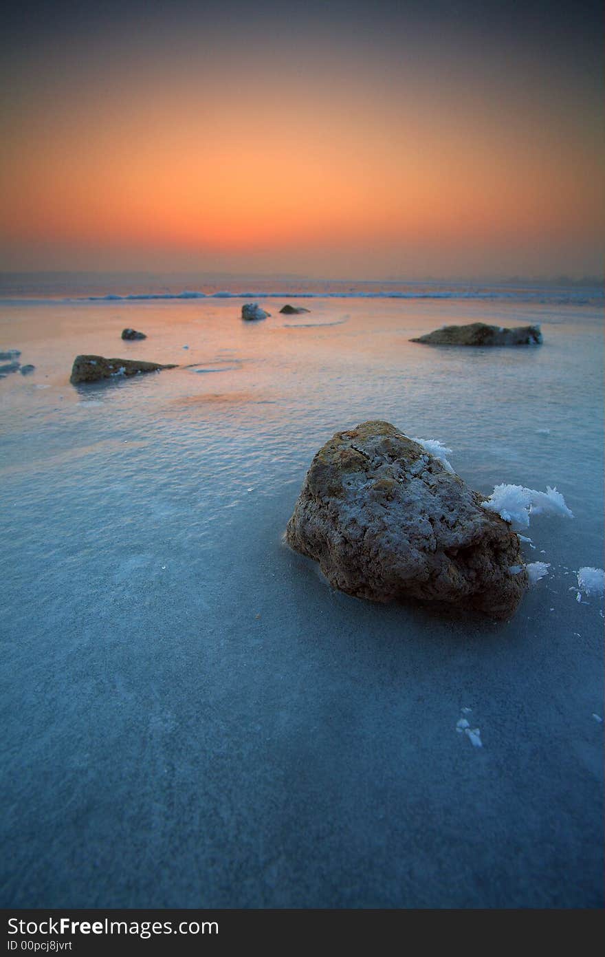 Frozen lake with stones and snow. Frozen lake with stones and snow