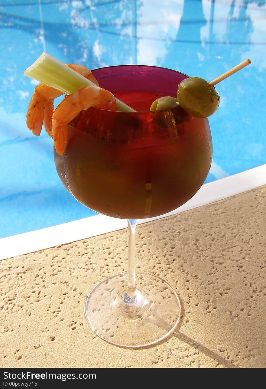 Bloody Mary cocktail by a swimming pool. Bloody Mary cocktail by a swimming pool