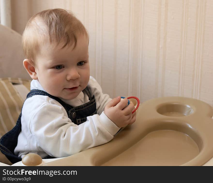 Adorable baby sits at a table