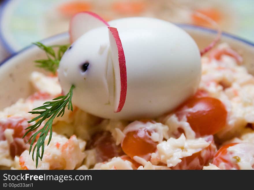 Chinese 2008 New Year symbolic mouse made from egg and radish at the top of served salad