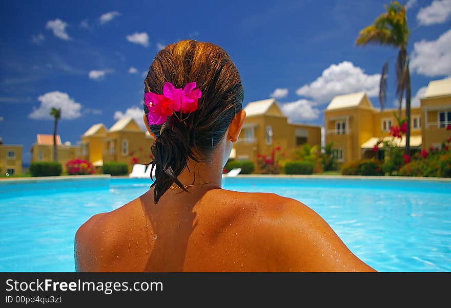 Woman sitting by edge of pool