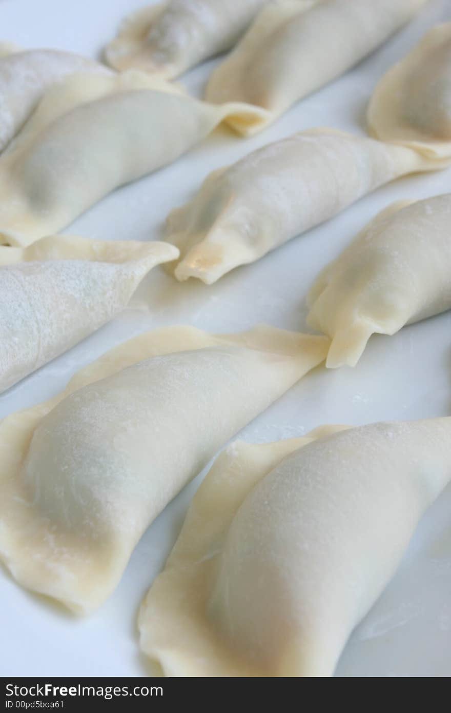 Uncooked dumpling, also known as gyoza, on white background. Uncooked dumpling, also known as gyoza, on white background