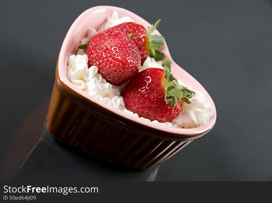 A tasty strawberry dessert isolated on black. A tasty strawberry dessert isolated on black