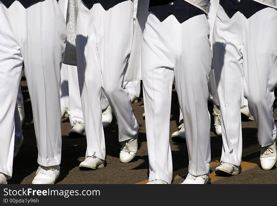 College marching band members legs in unison in Fiesta Bowl parade. College marching band members legs in unison in Fiesta Bowl parade.