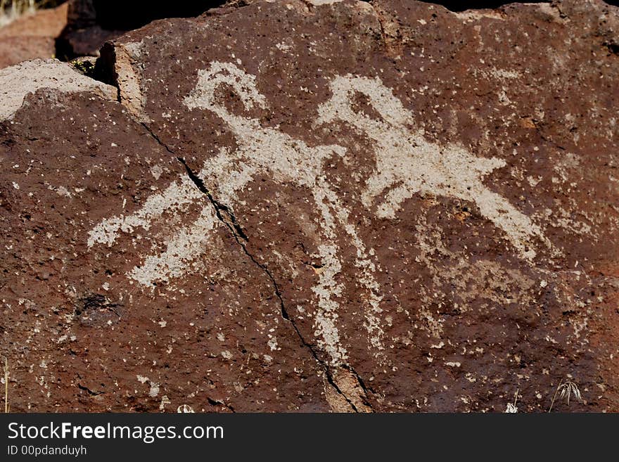 Native American rock art petroglyph close up of two sheep like figures carved into desert varnish covered rock in Little Petroglyph Canyon of the Coso Range in California. Native American rock art petroglyph close up of two sheep like figures carved into desert varnish covered rock in Little Petroglyph Canyon of the Coso Range in California