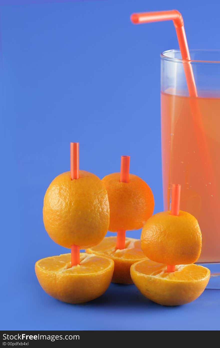 Image from creative series: boats of mandarins and juice on blue background