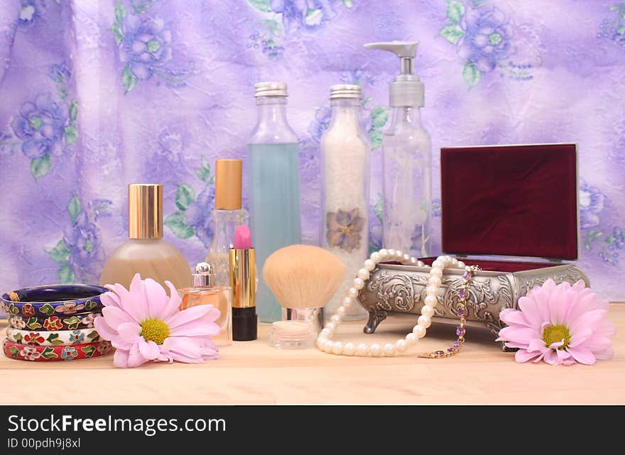 Cosmetics and Jewelry With Perfume on Table With Floral Background, Shallow DOF