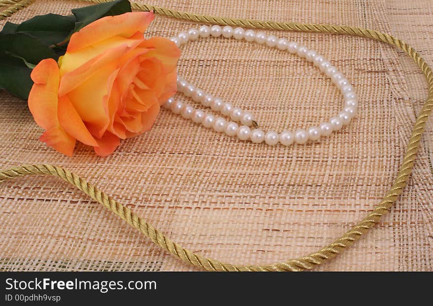 Rose on Textured Background With Pearls and Gold Rope. Rose on Textured Background With Pearls and Gold Rope