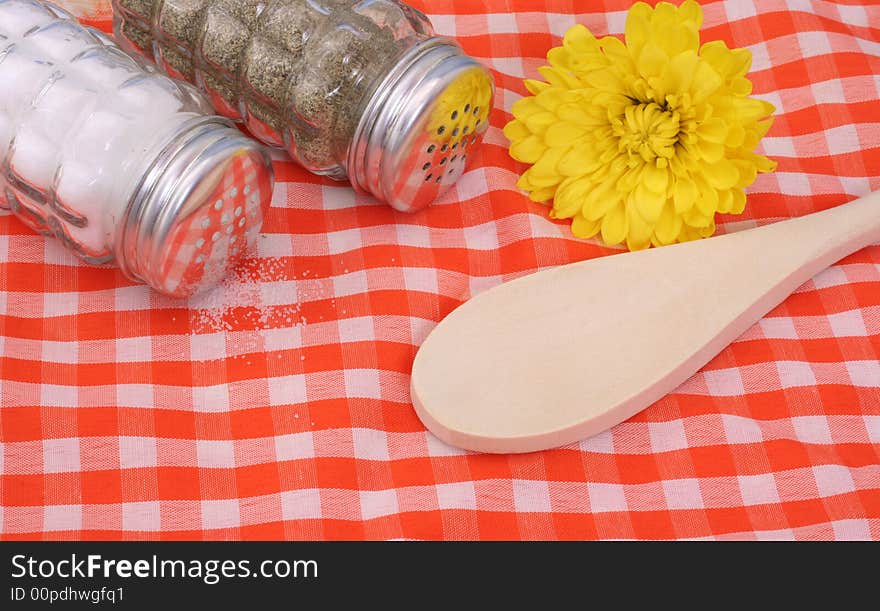 Salt and Pepper Shaker With Flower and Wooden Spoon