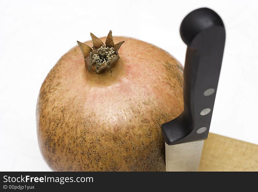 Juicy pomegranate as a dessert and a knife. Juicy pomegranate as a dessert and a knife