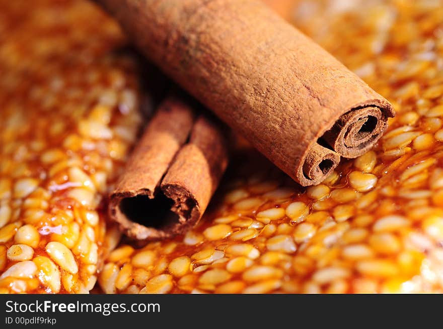 Close up of cinnamon on sesame background. Close up of cinnamon on sesame background