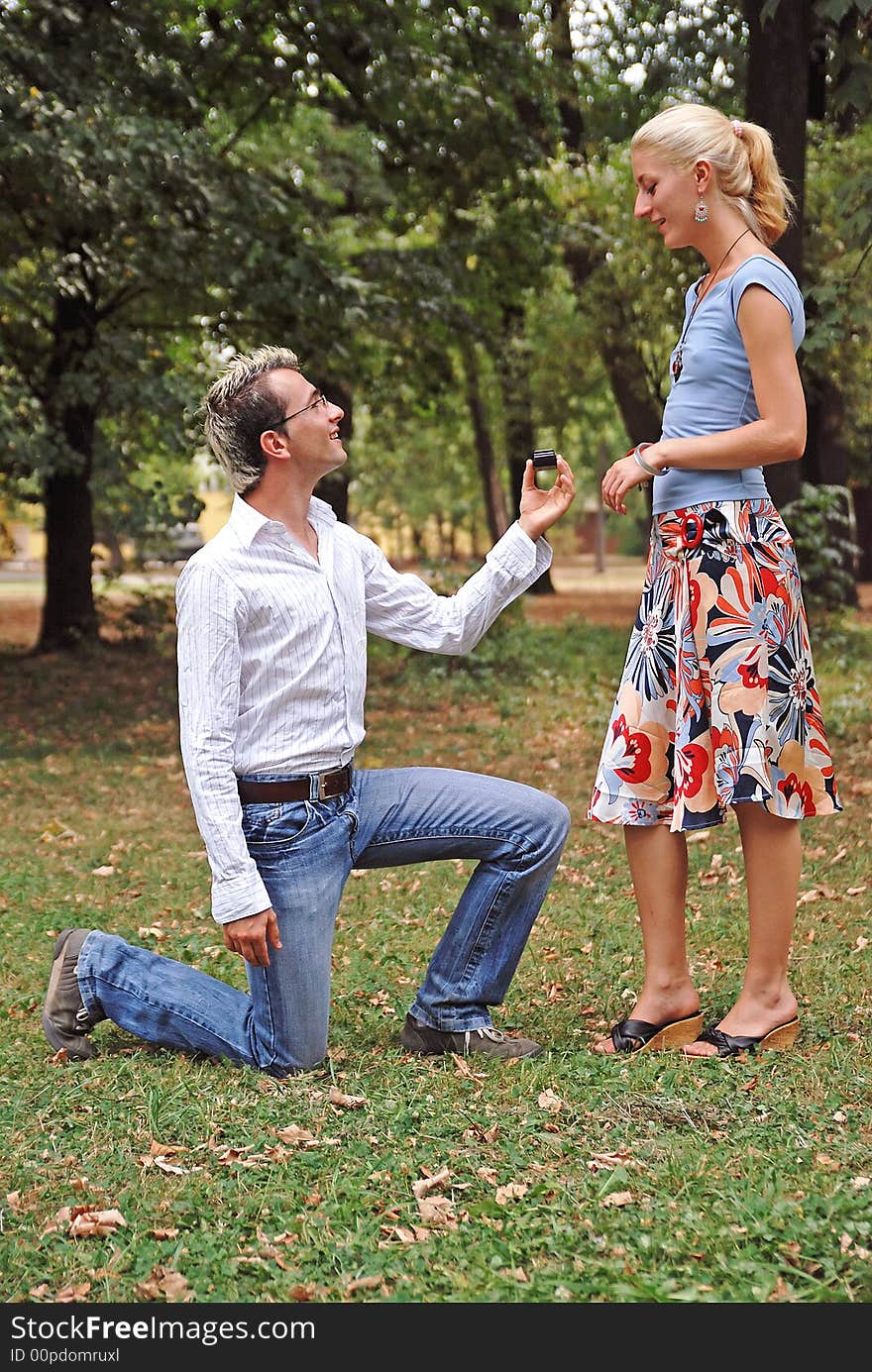 Man on his knees proposing his girlfriend. Man on his knees proposing his girlfriend