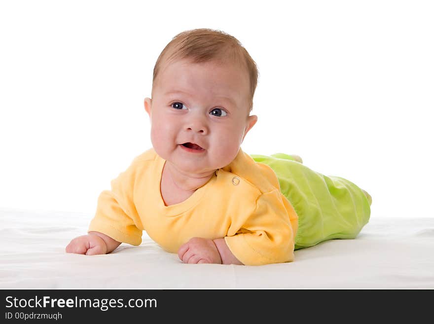 Smiling baby on bed isolated