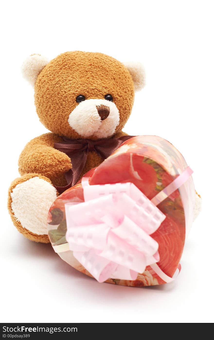 Classic brown Teddy Bear with heart-shaped present