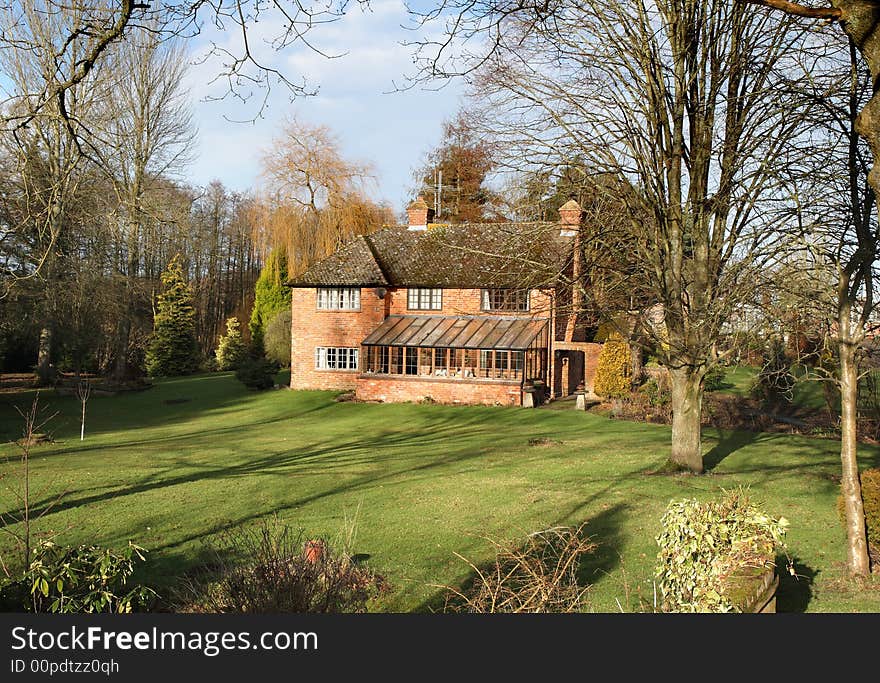 Traditional English Rural House and garden basking in Winter Sunshine