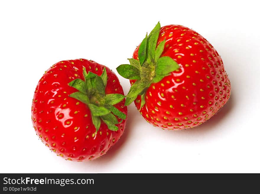 Two appetizing brightly red strawberries on a white background