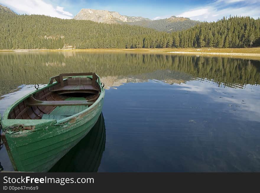 Green boat on the lake