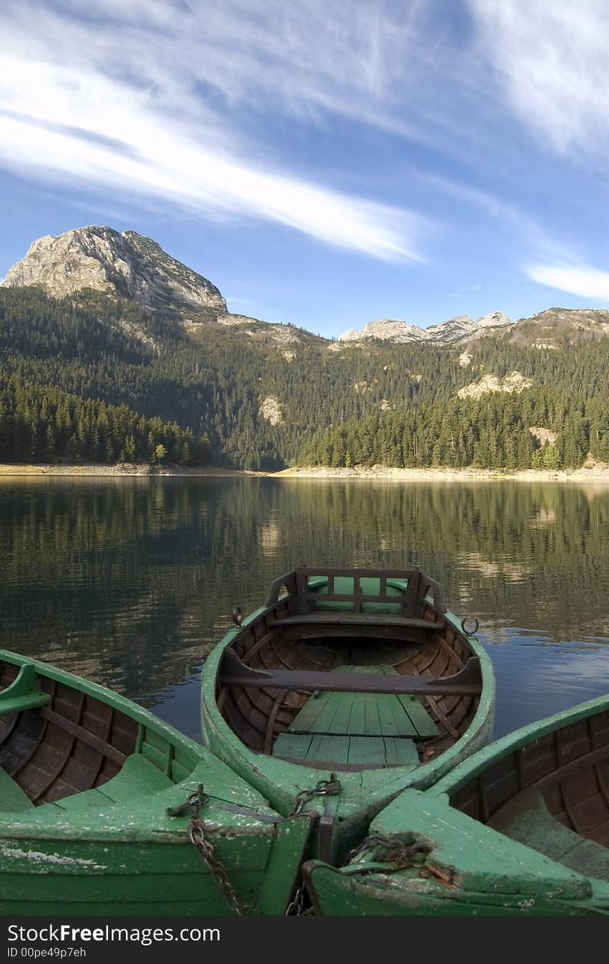 Three boats for fishing on the mountain lake