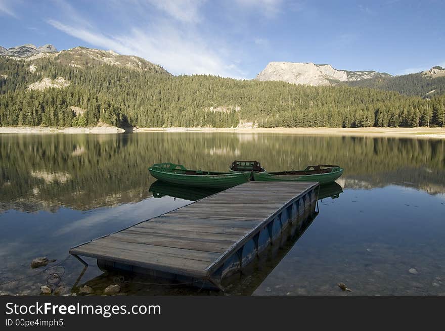 Three boats for fishing on the mountain lake