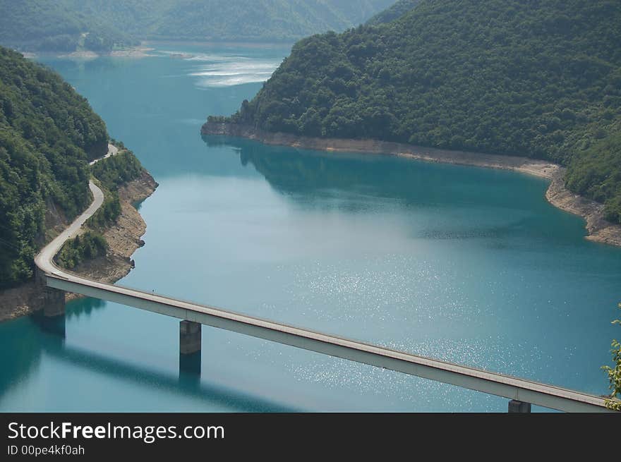 Bridge for the cars on the mountain lake