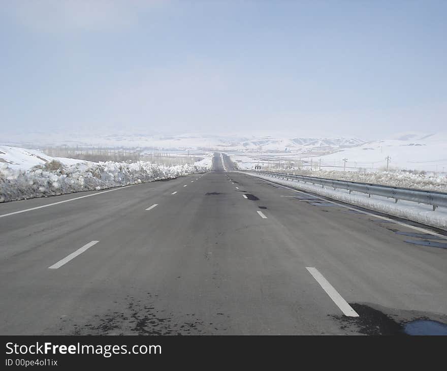 An endless road that coverd by very light snow that may reach to heaven. An endless road that coverd by very light snow that may reach to heaven