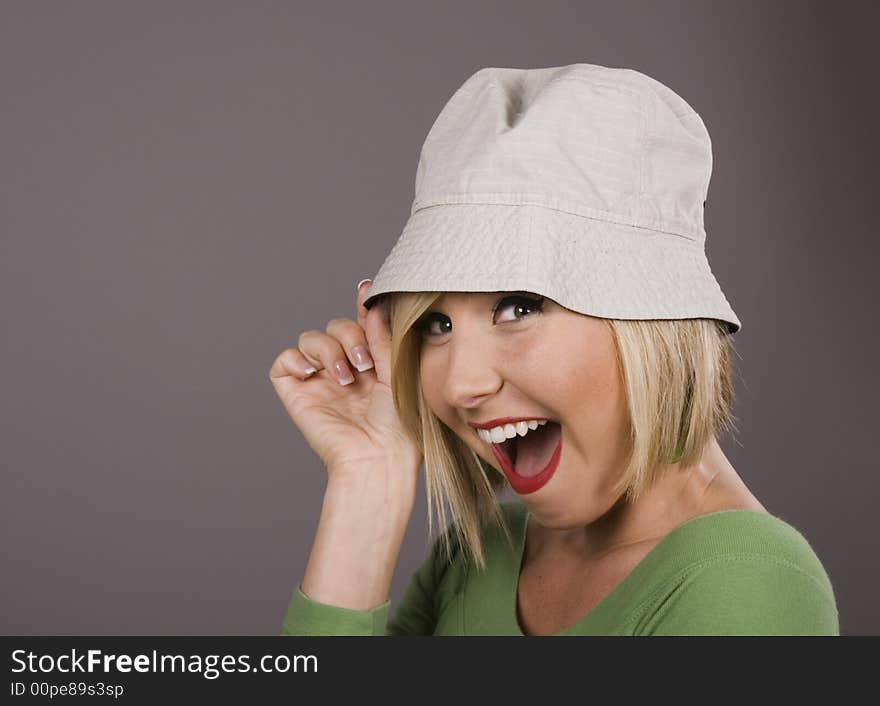 Blonde Holding Hat Smiling