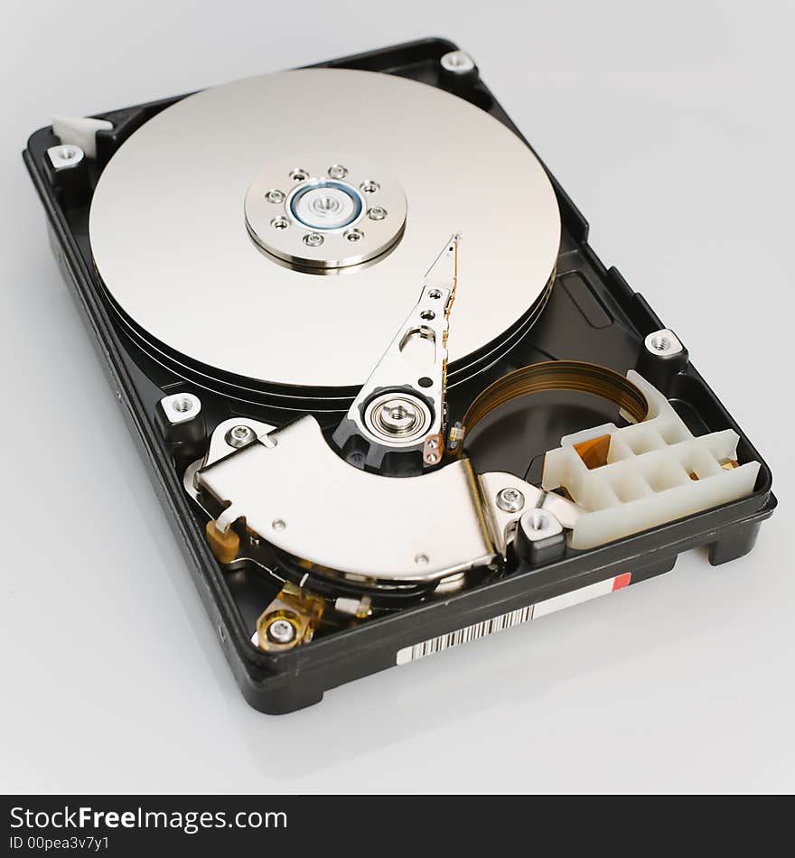 Modern opened hard disk drive over a white surface