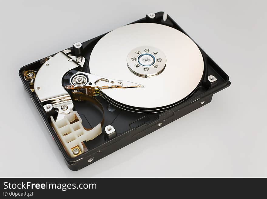 Modern opened hard disk drive over a white surface