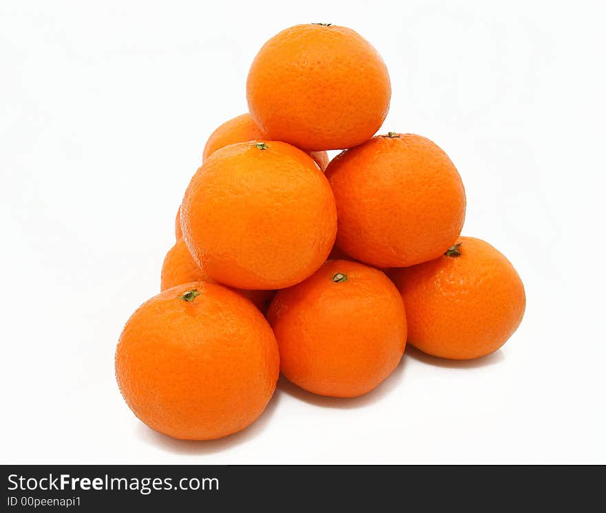 Pyramid from tasty ripe tangerines on a white background. Pyramid from tasty ripe tangerines on a white background.