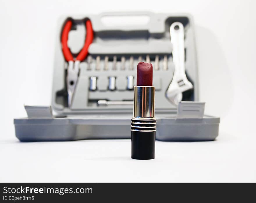 Lipstick on background with instruments' kit. Lipstick on background with instruments' kit