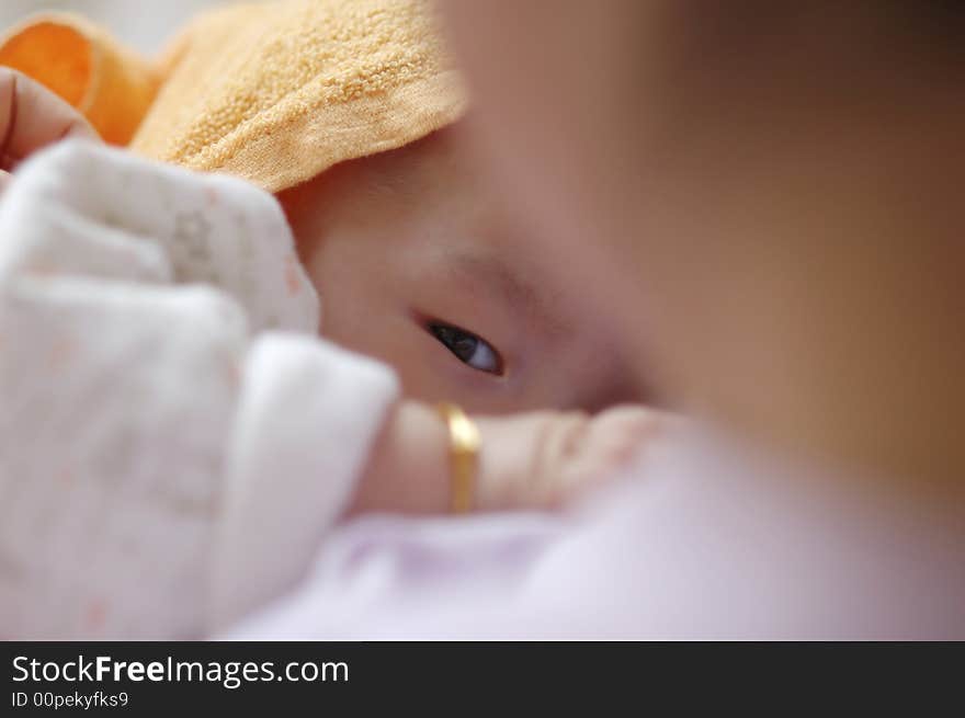 Baby suckling in mother's arms