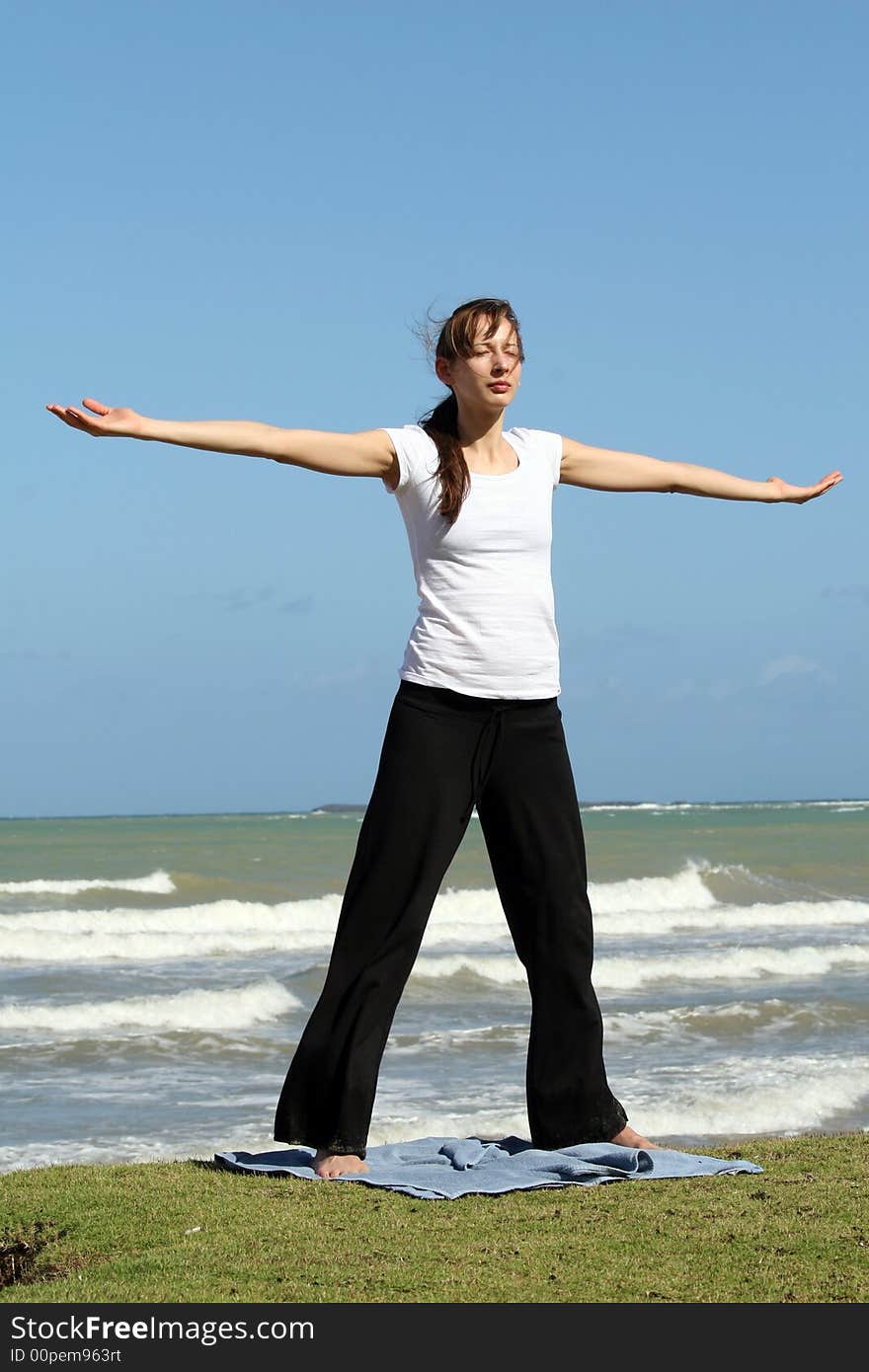 woman doing relaxing and yoga exercises on the beach. woman doing relaxing and yoga exercises on the beach