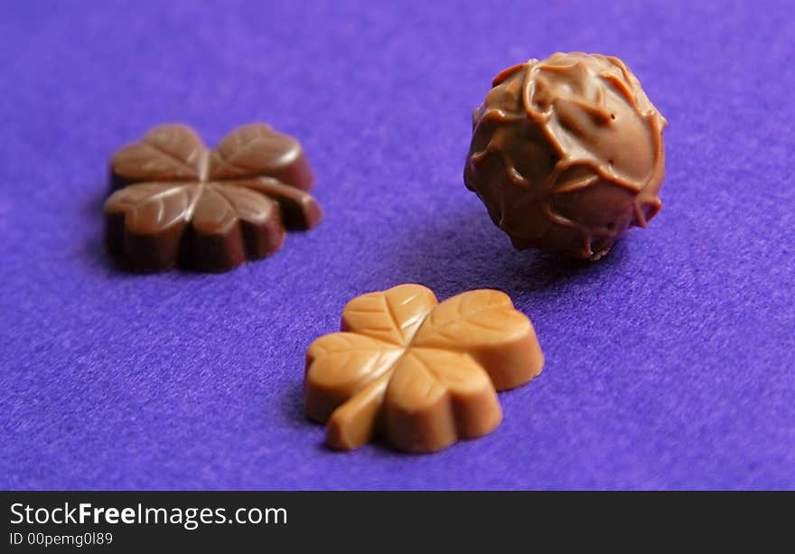 Fancy chocolates on a violet velvet background. Fancy chocolates on a violet velvet background