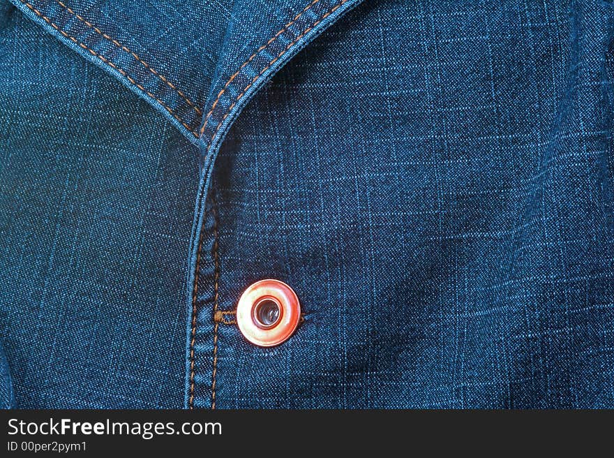 Close up of blue jeans jacket with button