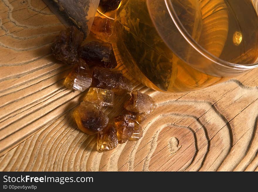 White tea, nylon tea-bag and brown sugar on the old wood