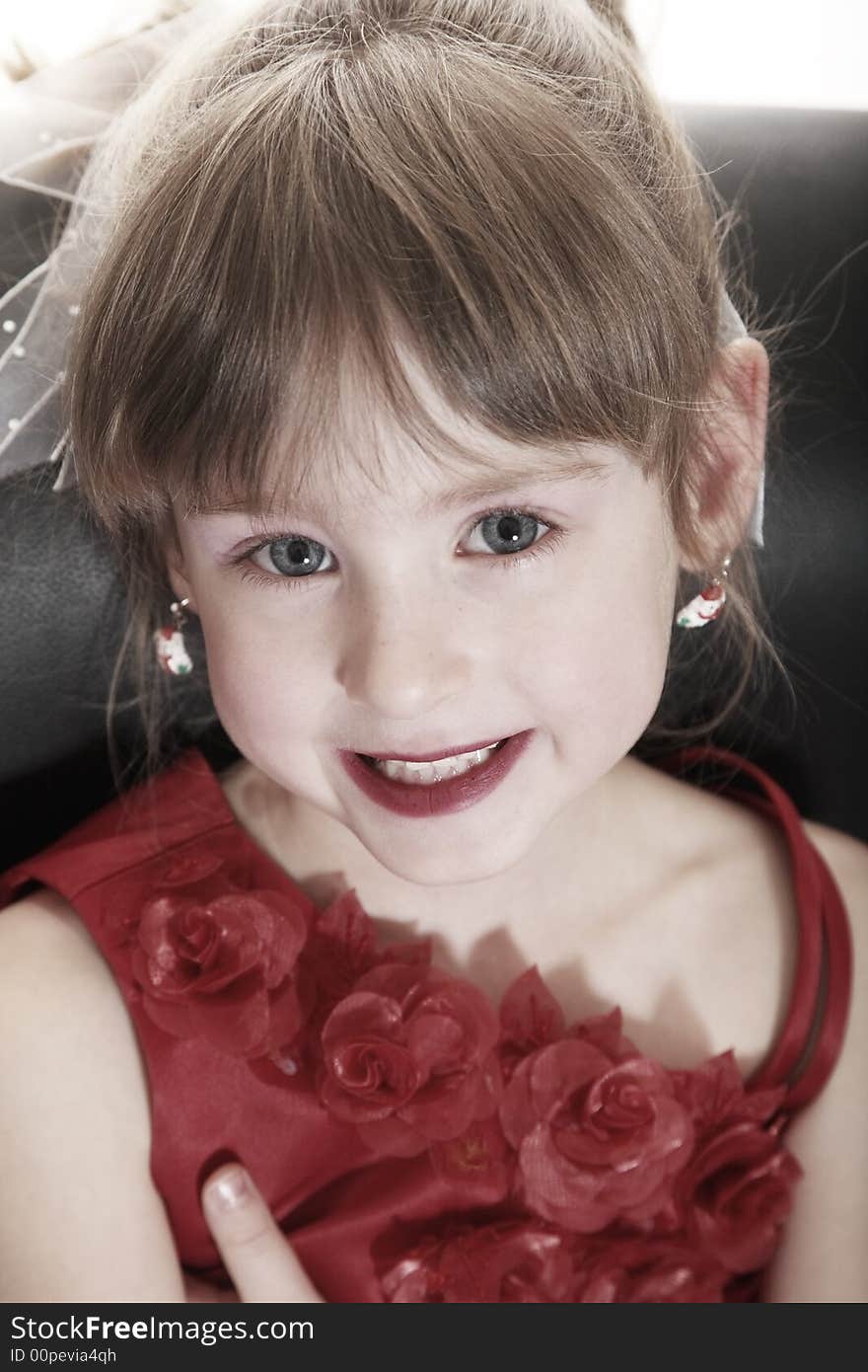 Portrait of a little girl in a fancy red dress. Portrait of a little girl in a fancy red dress.