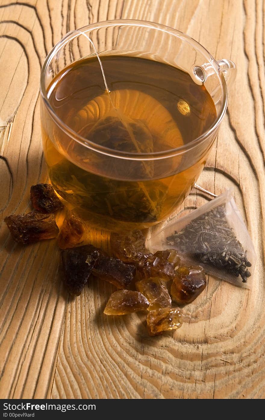 White tea, nylon tea-bag and brown sugar on the old wood