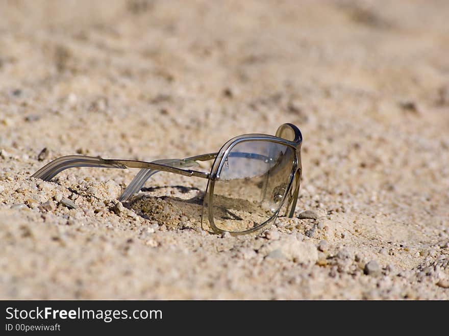 Sunglasses on the beachsand. Low depth of field.